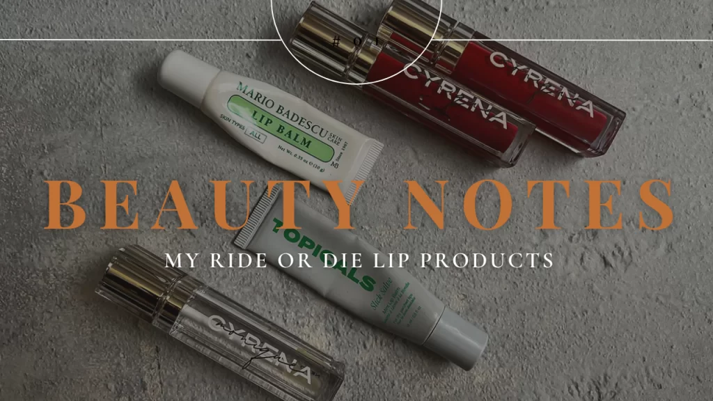 Flat lay of lip glosses, balms, and lipstick on a chic vanity with soft lighting