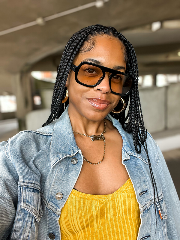 Black woman with glowing skin and braids